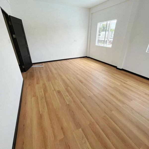 High-density SPC flooring with natural wood grain texture.